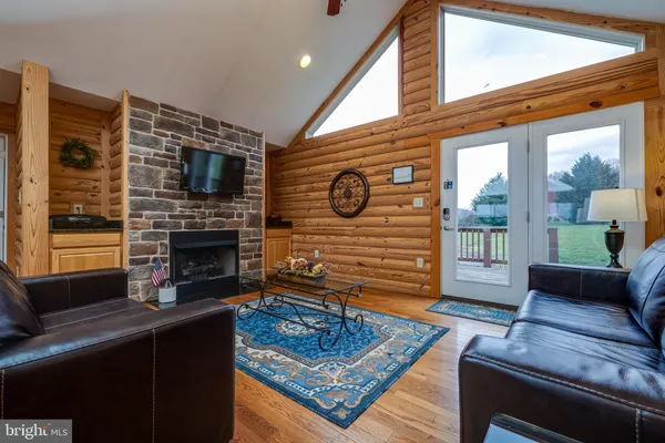 a room with furniture a window and a flat screen tv