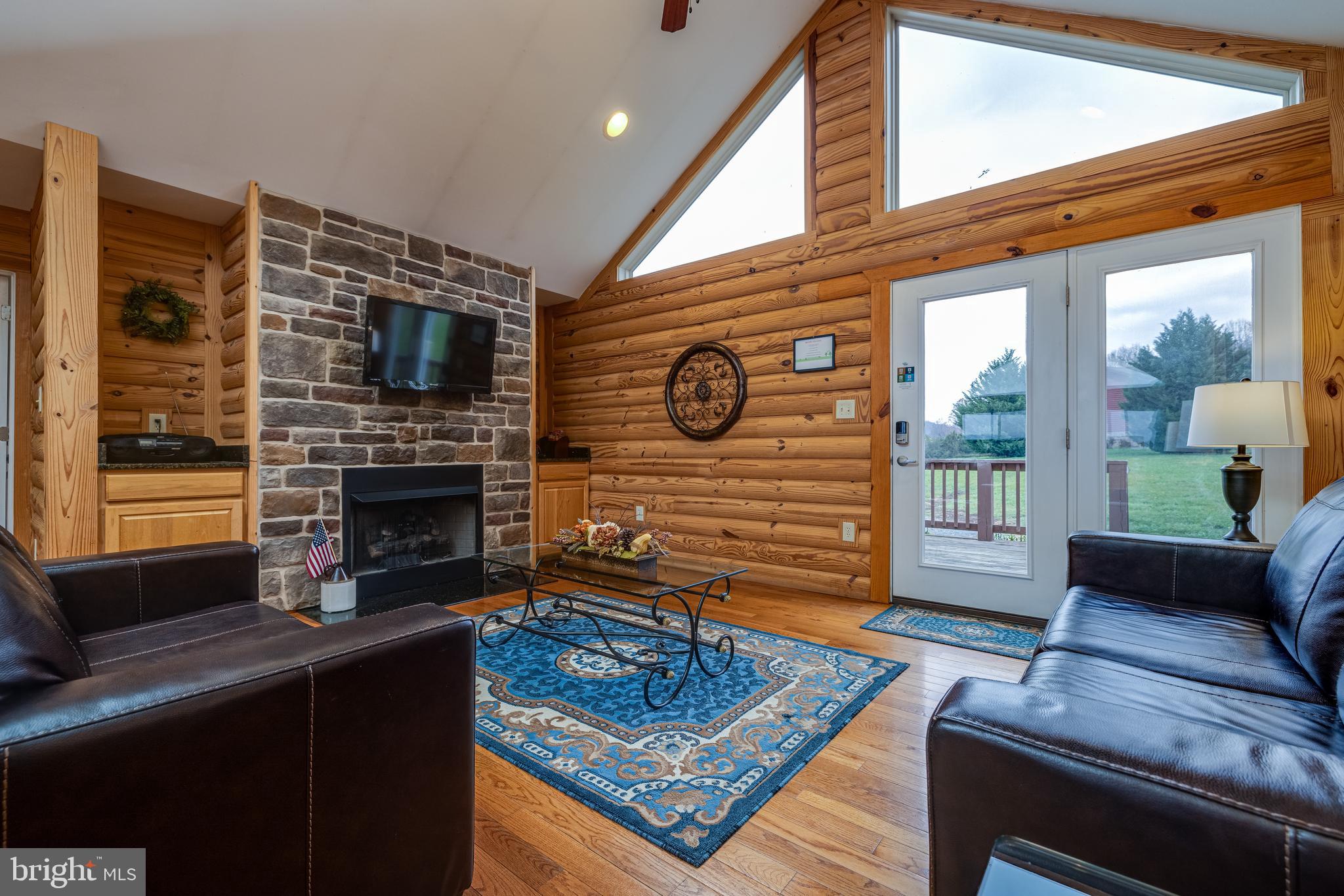 2225 Valley Burg Road Luray, VA 22835 - Photo 45 of 74 a living room with furniture a flat screen tv and a fireplace