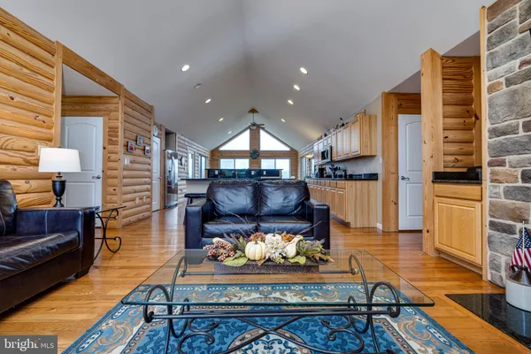 a living room with furniture a table and a large window