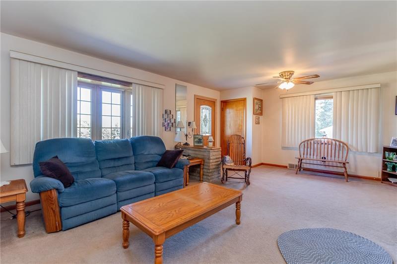 330 Highway 68 Rochester, PA 15074 - Photo 5 of 19 20x15 Living room with plenty of space for a dining area, loads of natural light and hardwood floors under the carpet.
