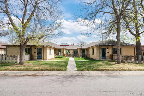 a house that has a tree in front of it