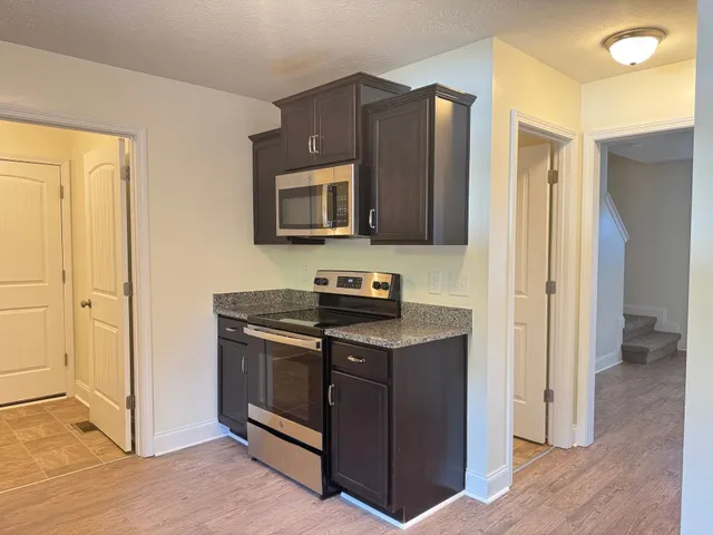 a kitchen with stainless steel appliances granite countertop a stove and a refrigerator