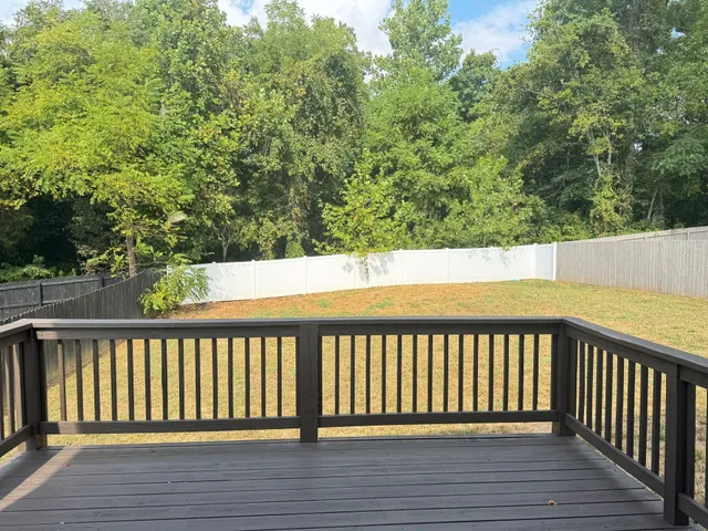 a balcony with wooden floor and fence