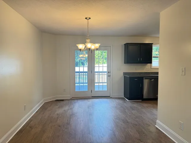 an empty room with a fireplace and windows