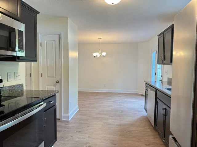 a kitchen with granite countertop a stove and a sink