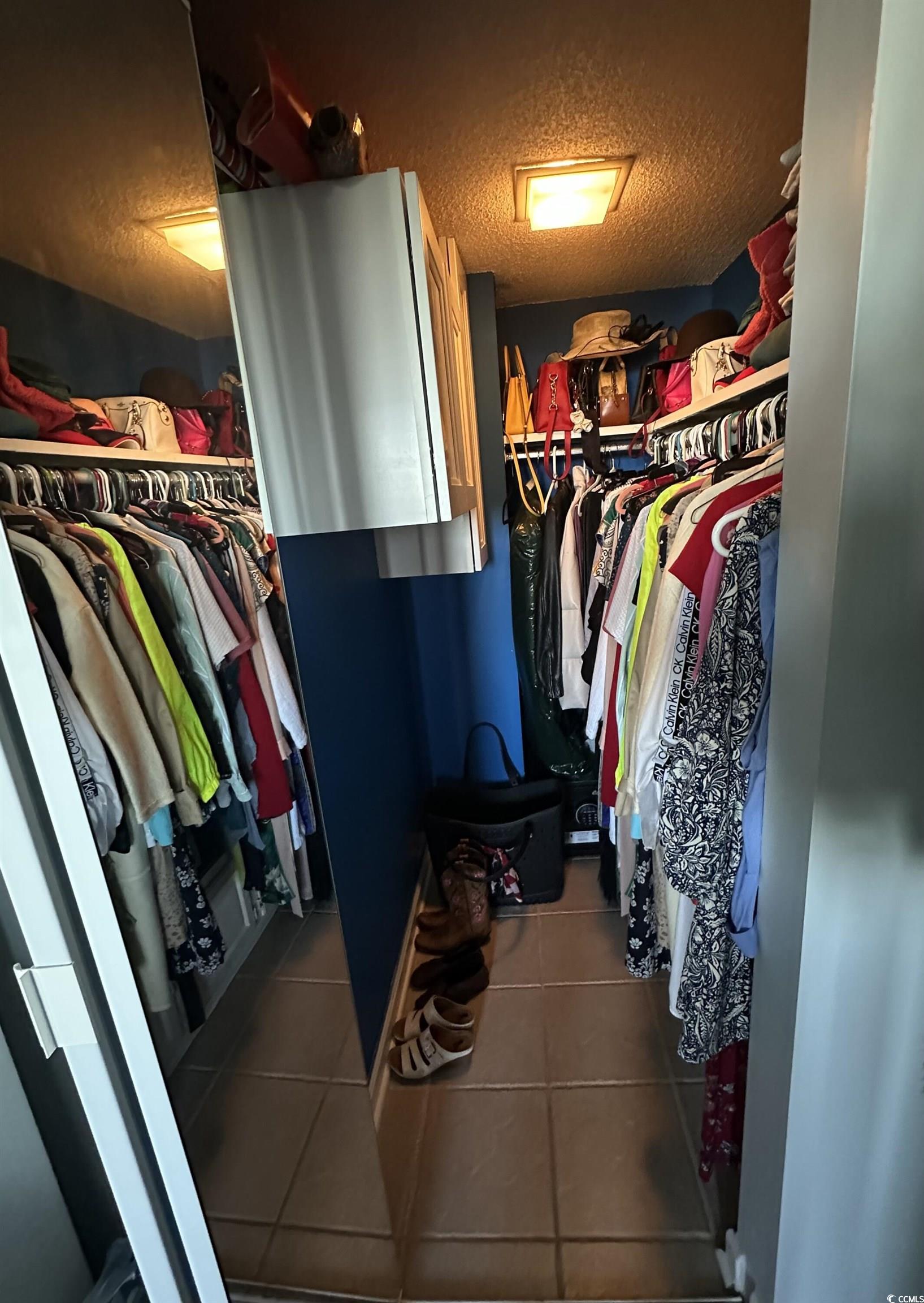 601 Mitchell Drive, Unit 1401 Myrtle Beach, SC 29577 - Photo 12 of 25 Walk in closet with dark tile patterned floors