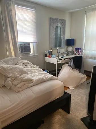 a bedroom with bed and window