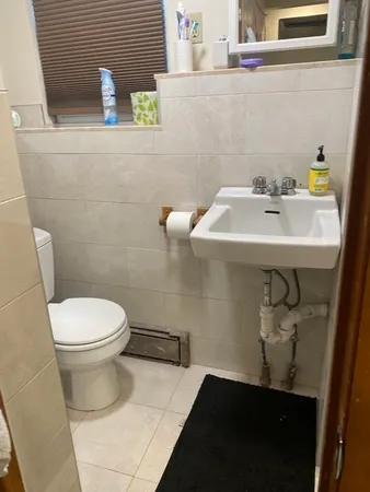 a bathroom with a sink a toilet and a mirror