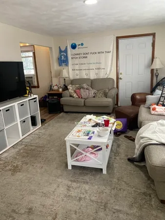 a bedroom with furniture and a flat screen tv