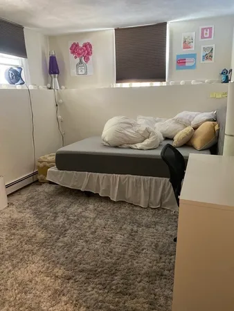 a bedroom with a bed and a couch