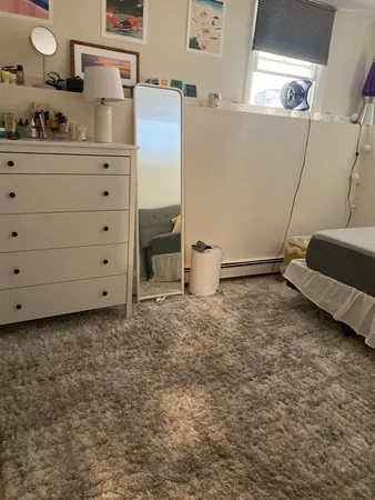 a room with a dresser and a mirror