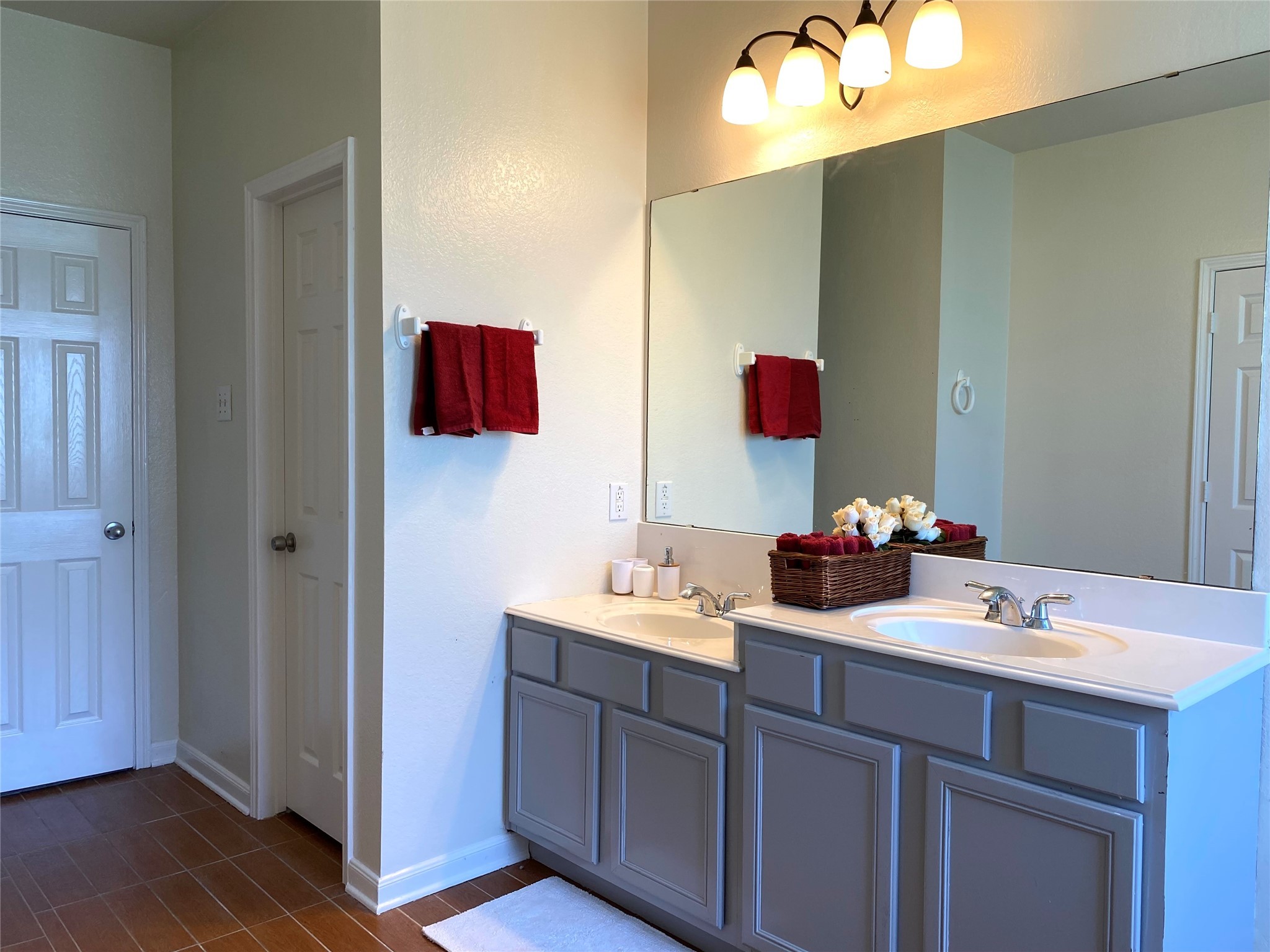 8138 Wooded Terrace Lane Humble, TX 77338 - Photo 22 of 36 a bathroom with a double vanity sink and a mirror