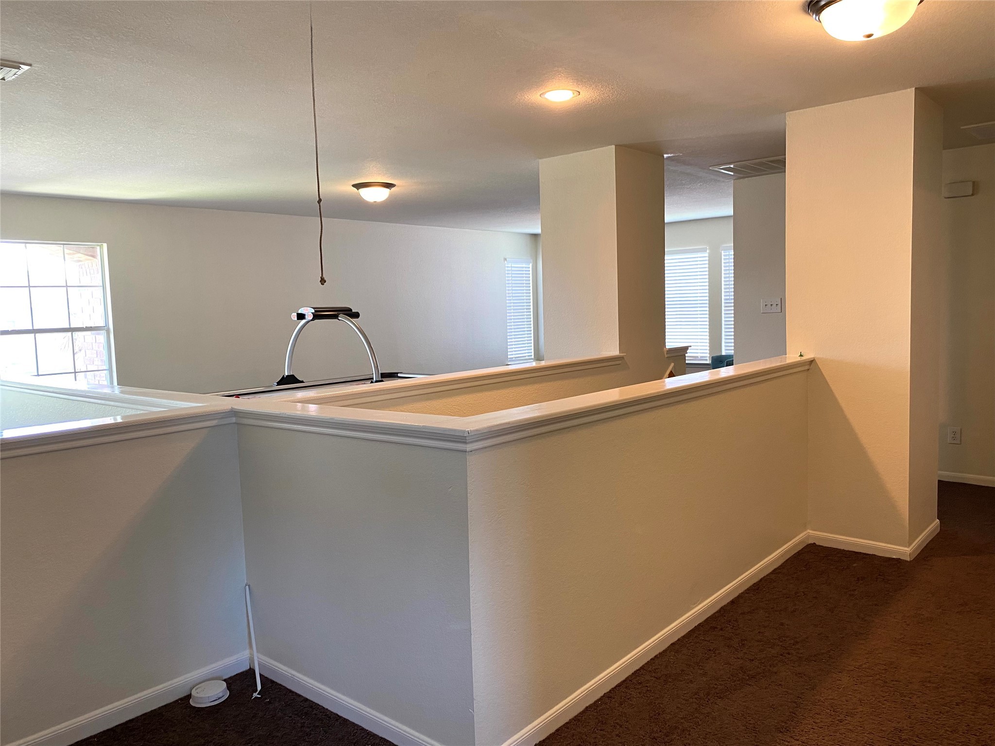 8138 Wooded Terrace Lane Humble, TX 77338 - Photo 28 of 36 a view of a hallway with a chair and wooden floor