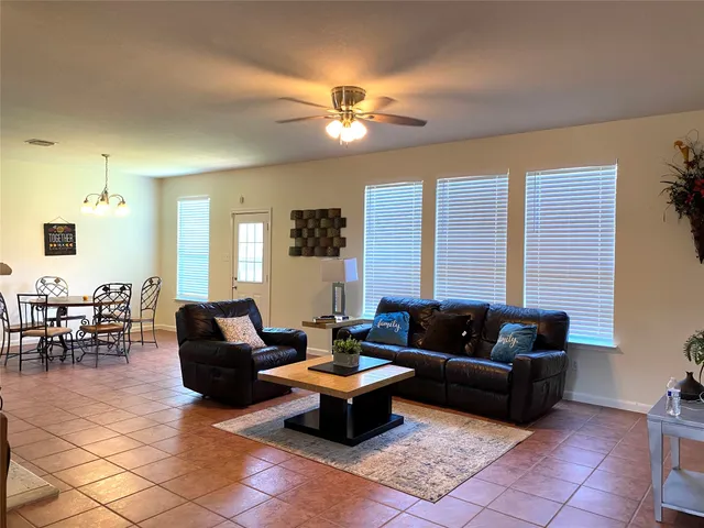 a living room with furniture and view of kitchen