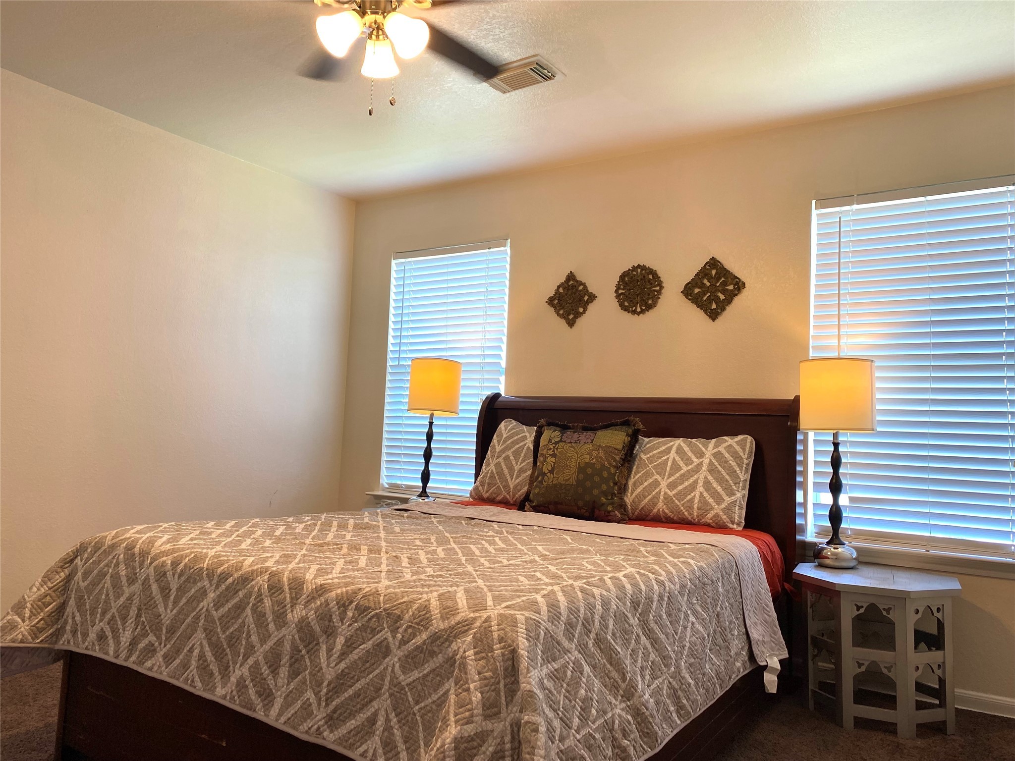 8138 Wooded Terrace Lane Humble, TX 77338 - Photo 35 of 36 a bedroom with a bed and a chandelier