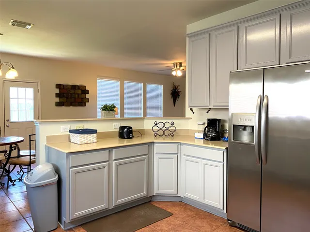 a kitchen with a sink stainless steel appliances and white cabinets
