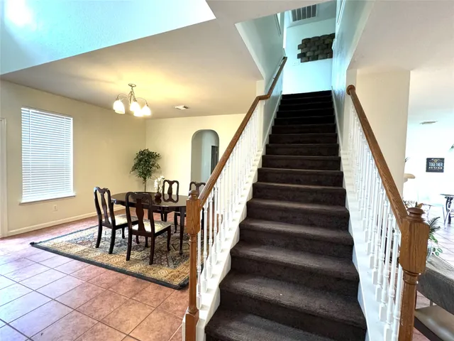 a view of a dining room with furniture and entryway