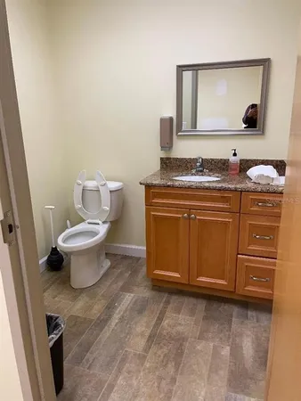 a bathroom with a toilet sink and mirror