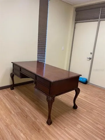 a living room with wooden floor and furniture