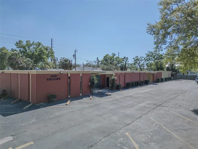 a backyard of a house with lots of green space and trees in the background