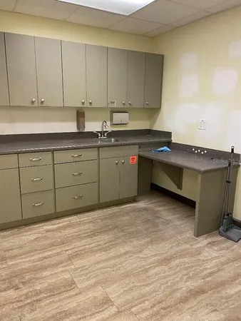 a kitchen with granite countertop a sink and cabinets