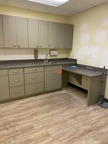 a kitchen with granite countertop a sink and cabinets