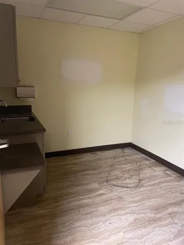 a view of an empty room and wooden floor