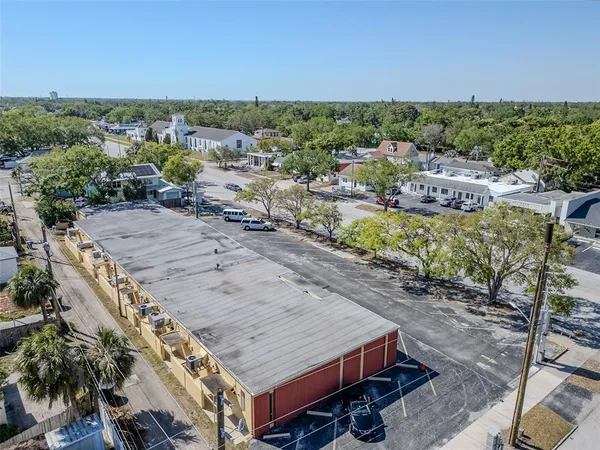 an aerial view of a house with a yard basket ball court and outdoor seating