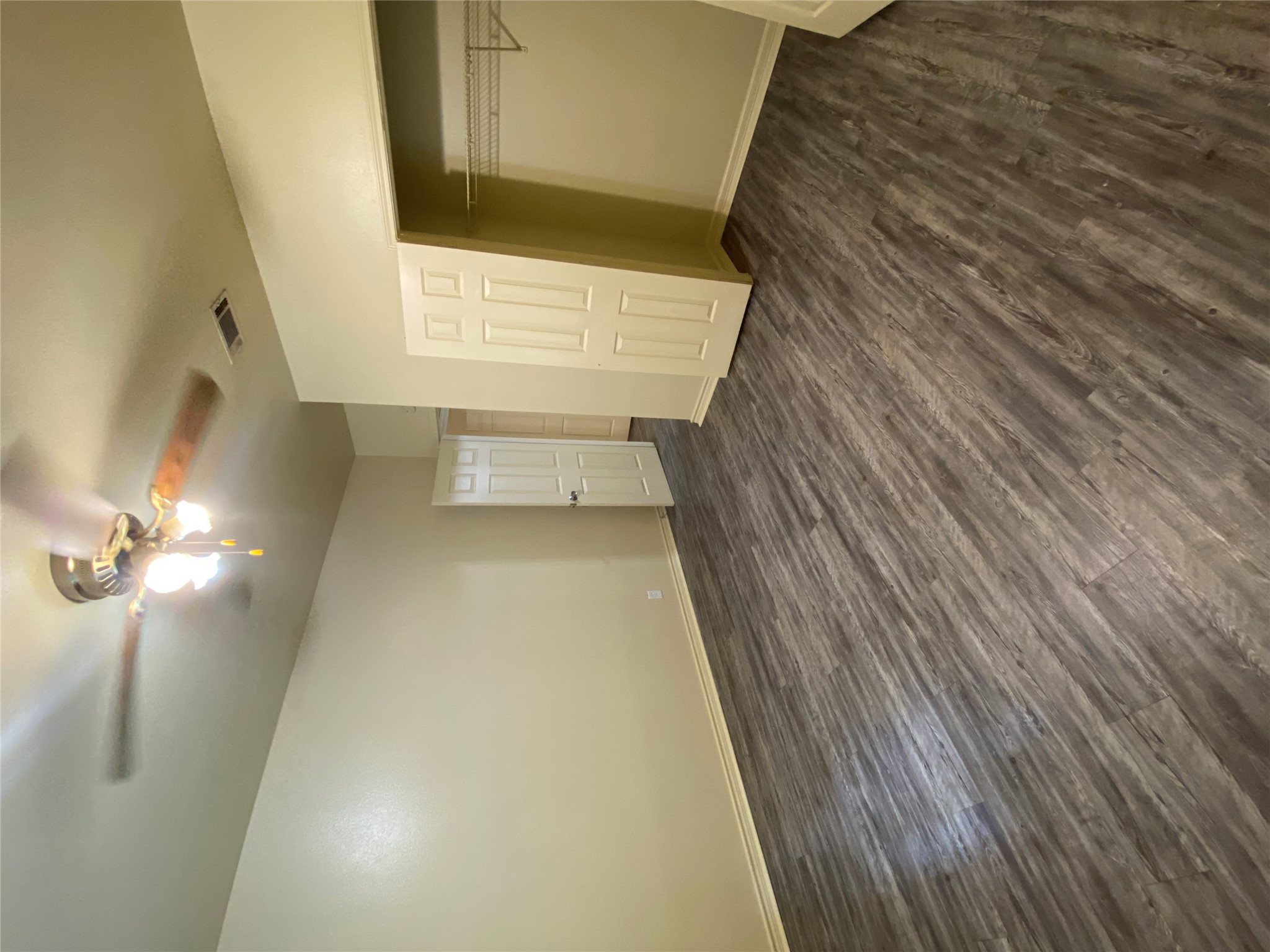 2605 Alcott Lane, Unit B Austin, TX 78748 - Photo 8 of 15 Well-appointed bedroom showcasing durable laminate flooring and a cooling ceiling fan.