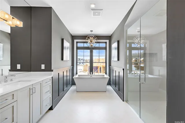 a spacious bathroom with a double vanity sink and large mirror