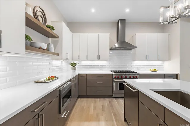a kitchen with stainless steel appliances granite countertop a sink stove and cabinets