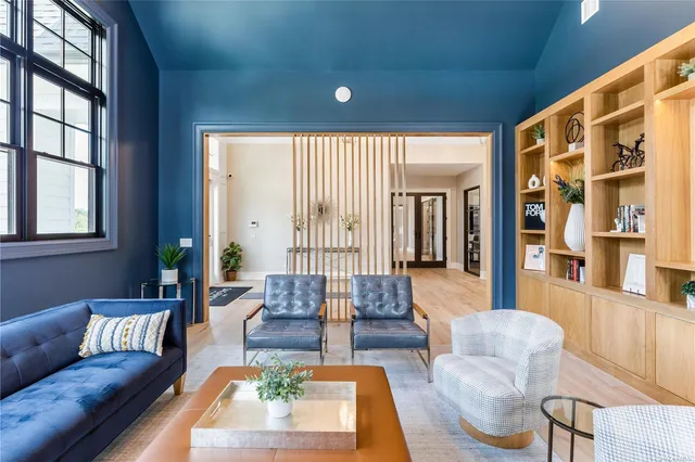 a living room with furniture wooden floor and a large window