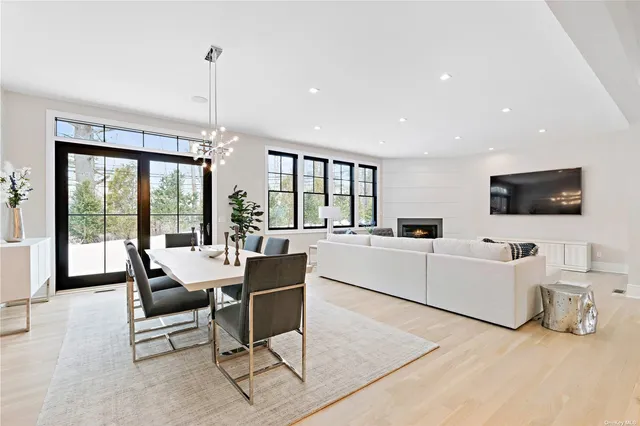 a living room with furniture tv and a large window