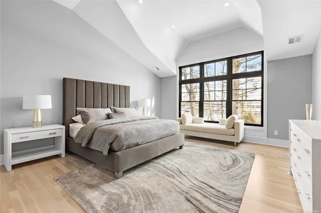 a bedroom with a large bed and a couch