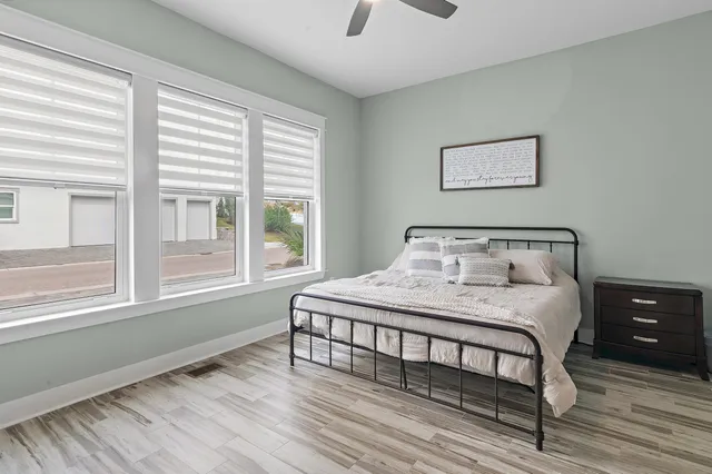 a bedroom with a bed and wooden floor