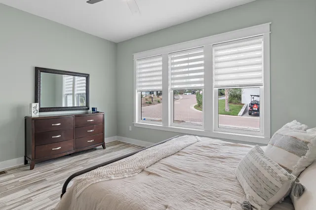a bedroom with a bed and a large window