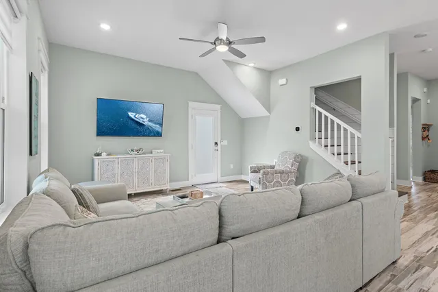 a living room with furniture and a ceiling fan