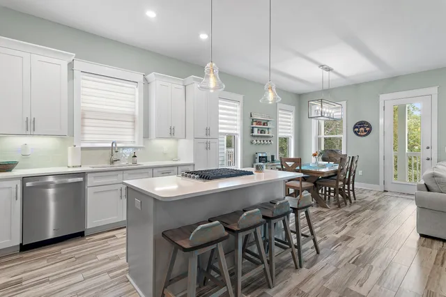 a kitchen with a table chairs stove and cabinets
