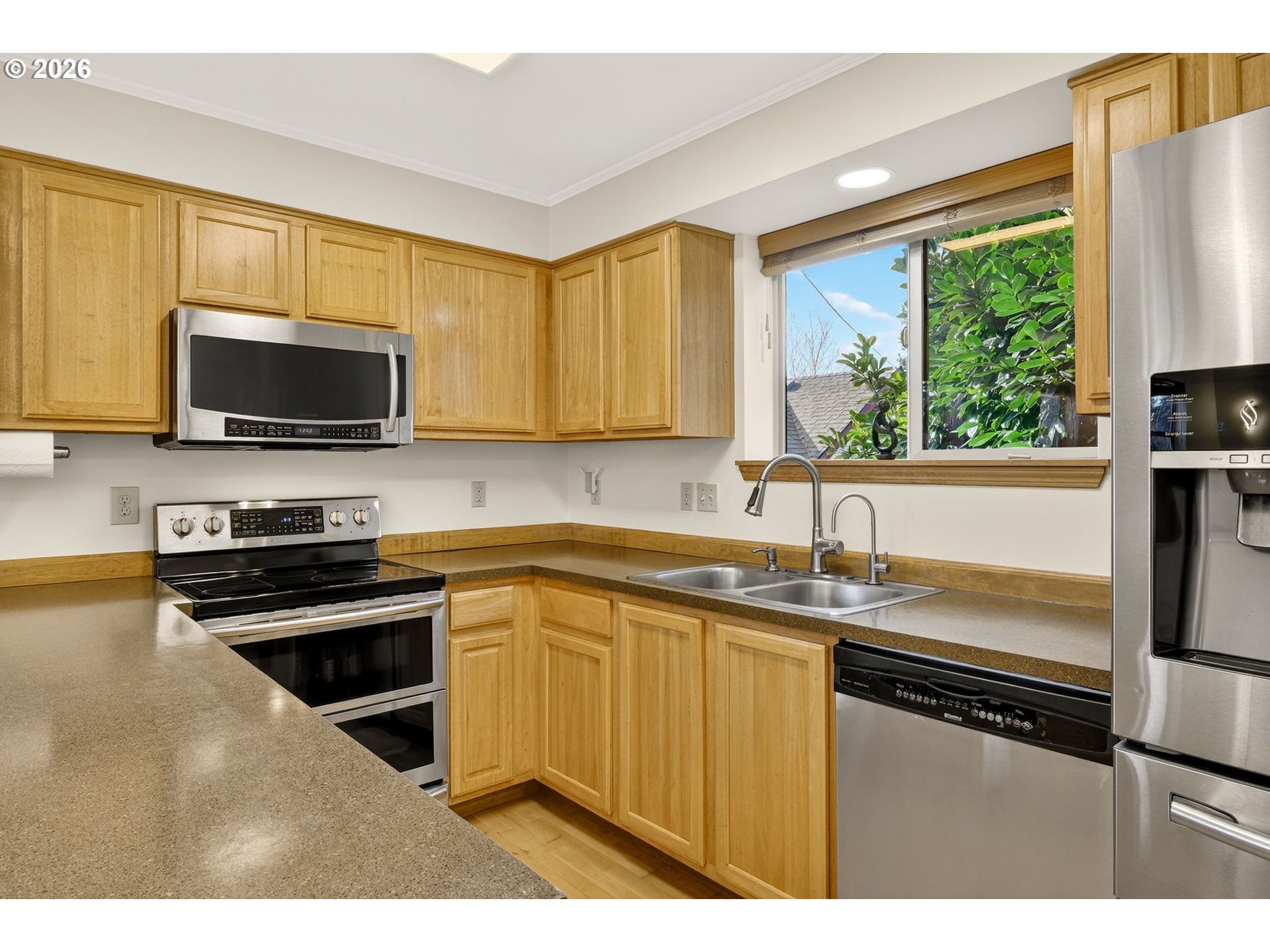 12132 Southeast Pardee Street Portland, OR 97266 - Photo 15 of 35 a kitchen with a sink stove top oven and cabinets