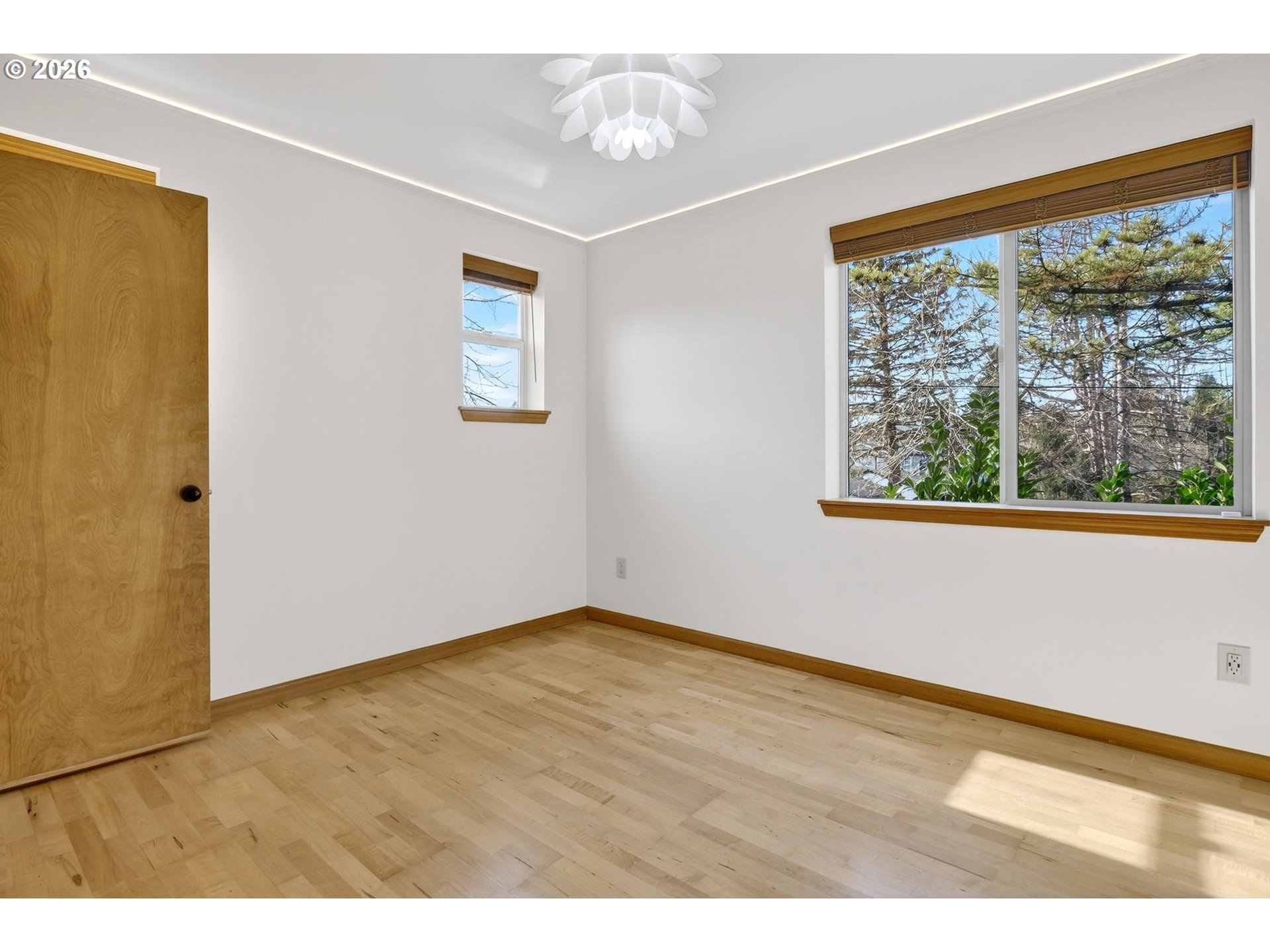 12132 Southeast Pardee Street Portland, OR 97266 - Photo 23 of 35 an empty room with wooden floor and windows