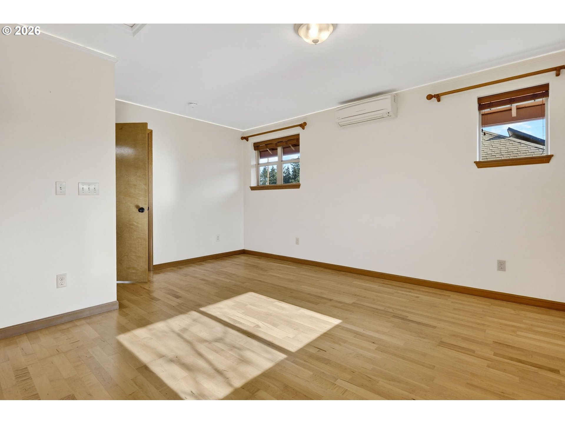 12132 Southeast Pardee Street Portland, OR 97266 - Photo 28 of 35 a view of an empty room with wooden floor