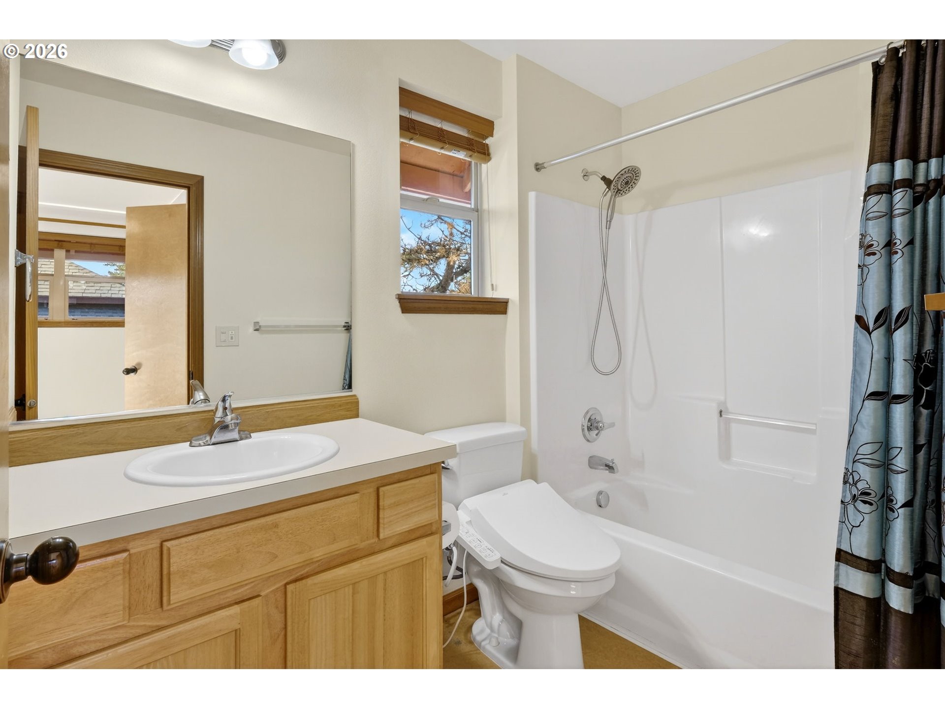 12132 Southeast Pardee Street Portland, OR 97266 - Photo 32 of 35 a bathroom with a sink a toilet a mirror a vanity and shower