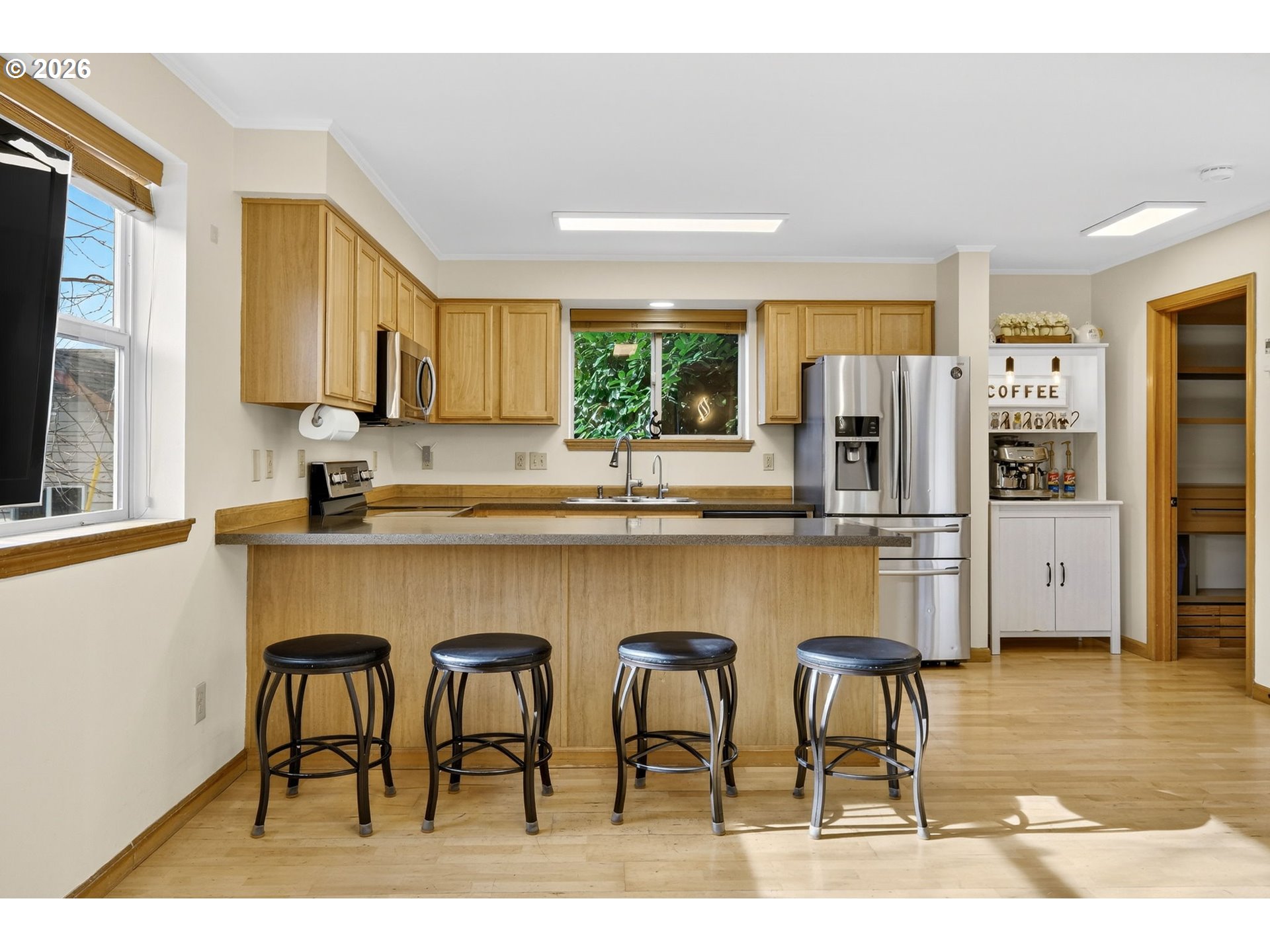 12132 Southeast Pardee Street Portland, OR 97266 - Photo 10 of 35 a kitchen with granite countertop a table chairs refrigerator and sink