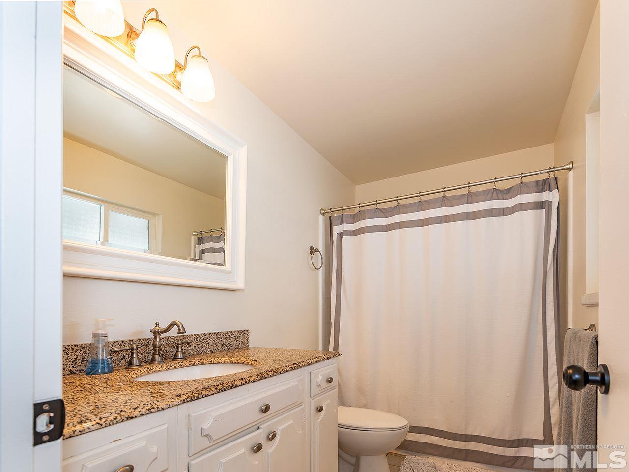 2065 Plumas Street Reno, NV 89509 - Photo 17 of 21 a bathroom with a granite countertop sink toilet and shower