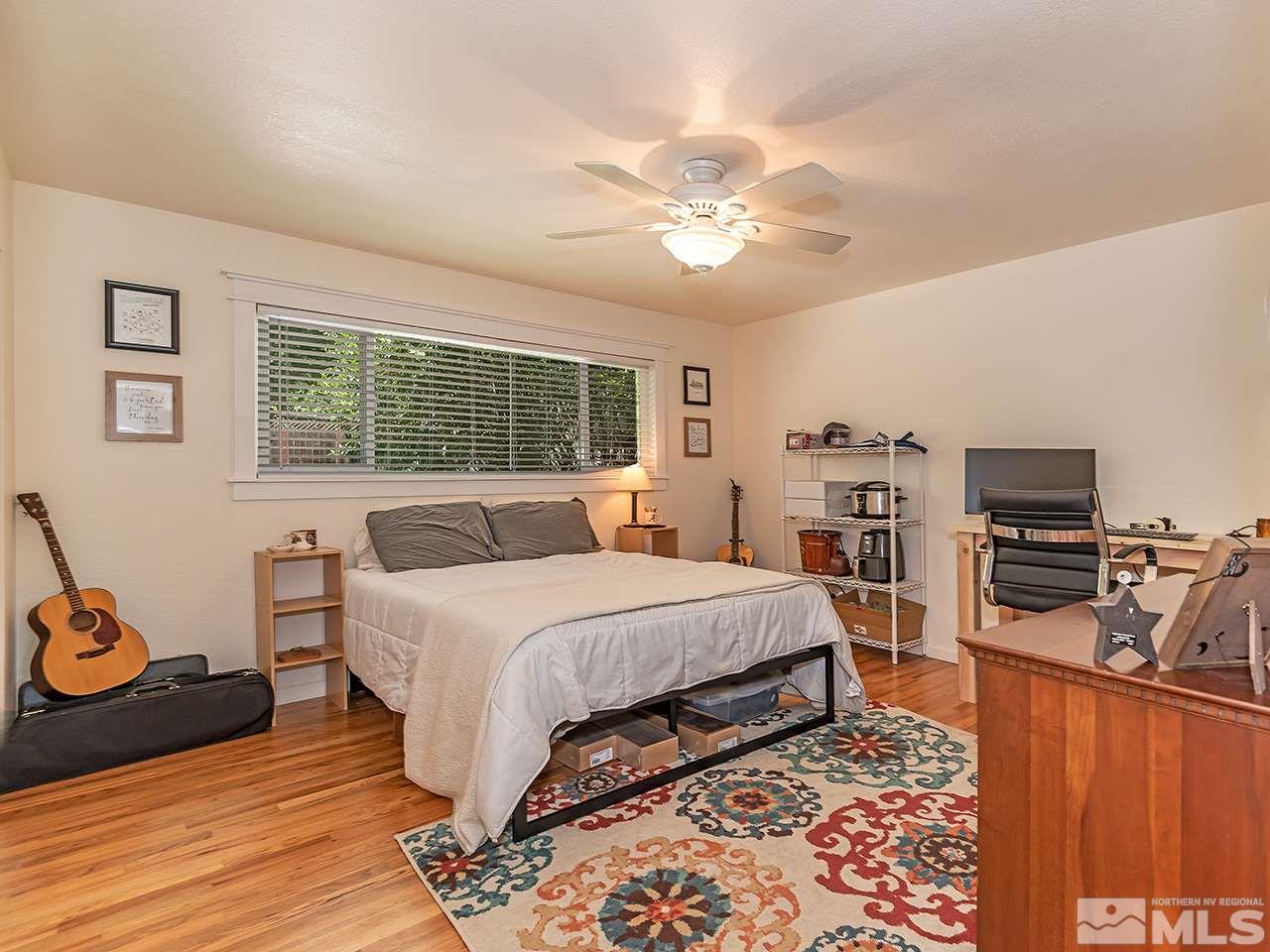 2065 Plumas Street Reno, NV 89509 - Photo 19 of 21 a bedroom with a bed and wooden floor