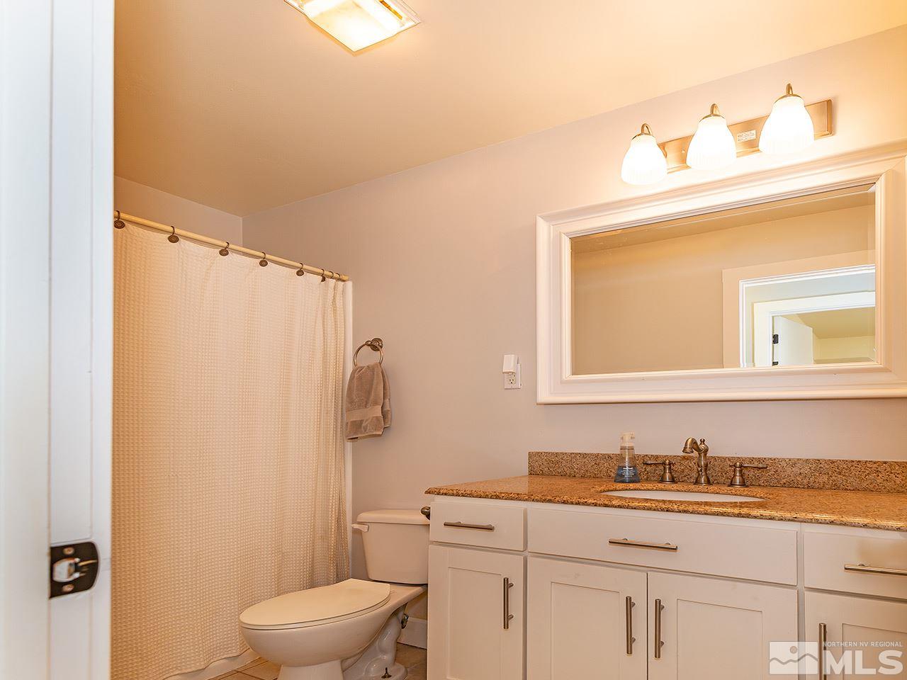 2065 Plumas Street Reno, NV 89509 - Photo 21 of 21 a bathroom with a sink a toilet and a mirror