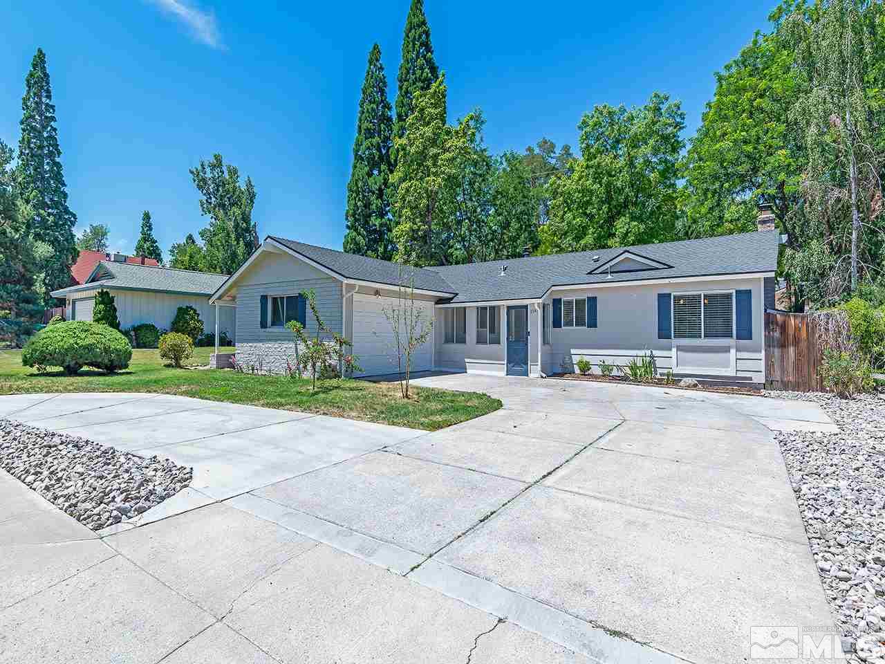 2065 Plumas Street Reno, NV 89509 - Photo 6 of 21 a house with lots of trees in the background