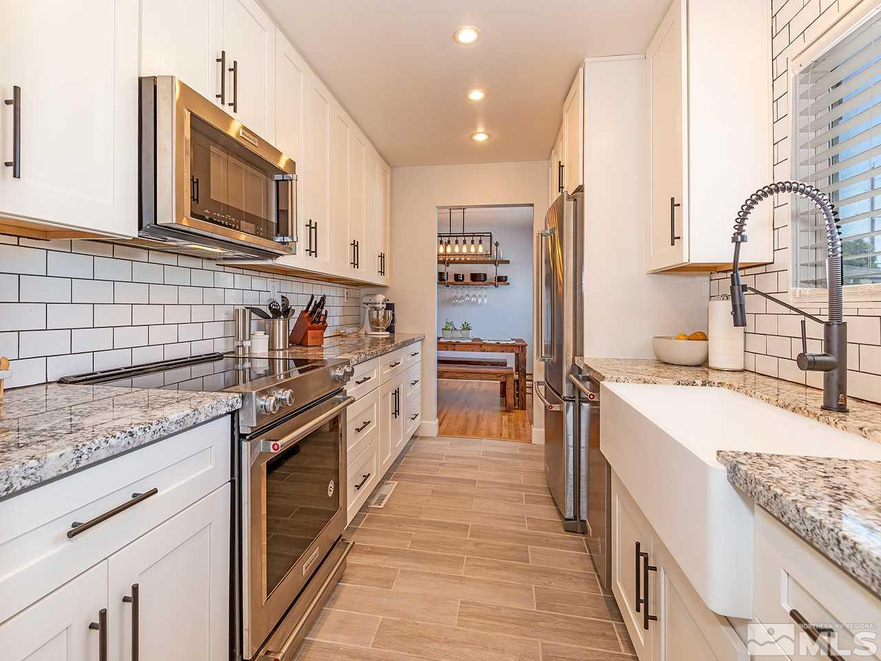 2065 Plumas Street Reno, NV 89509 - Photo 9 of 21 a kitchen with stainless steel appliances granite countertop lots of counter top space and wooden floor