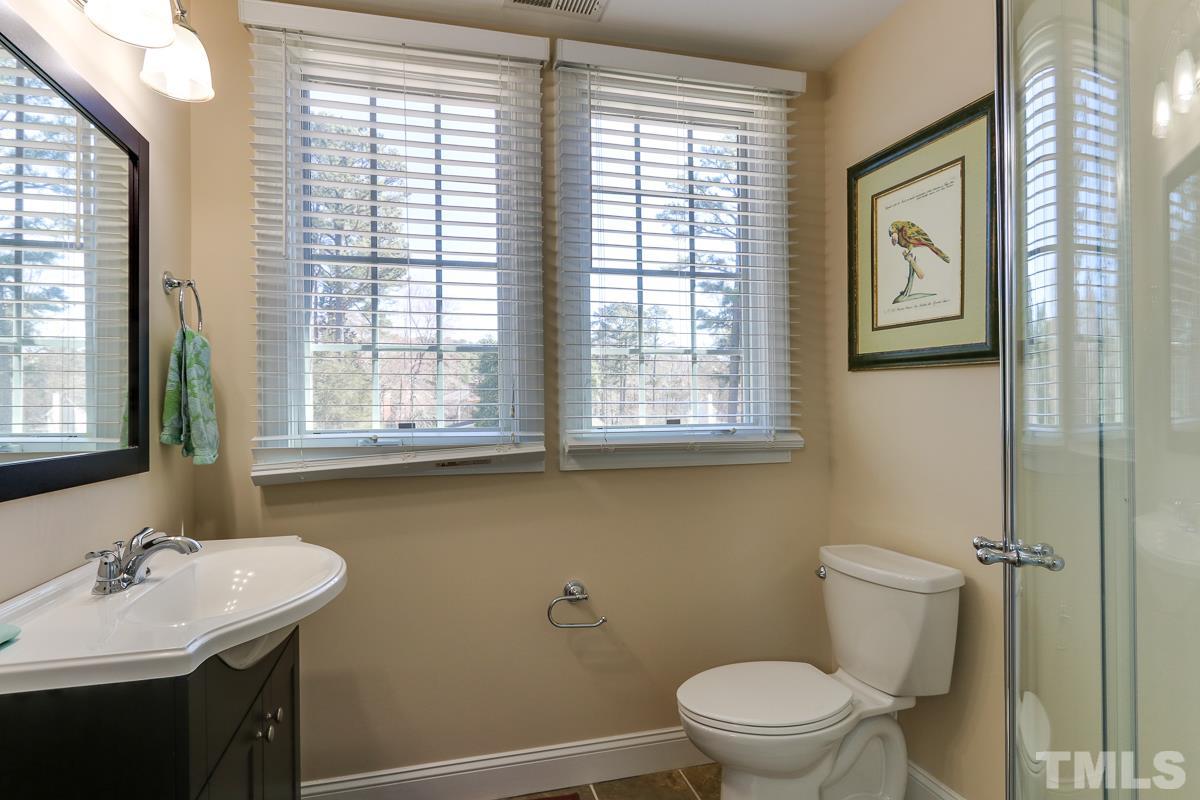 1705 Pony Run Road Raleigh, NC 27615 - Photo 11 of 22 a bathroom with a sink a toilet and a window