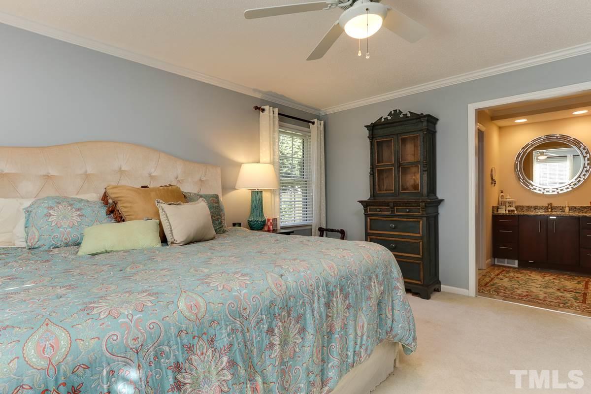 1705 Pony Run Road Raleigh, NC 27615 - Photo 13 of 22 a bedroom with a bed and a chandelier